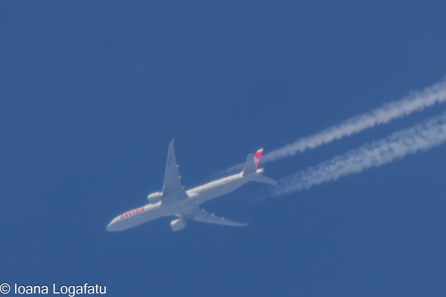 Elegant aircraft soars high in a clear blue sky